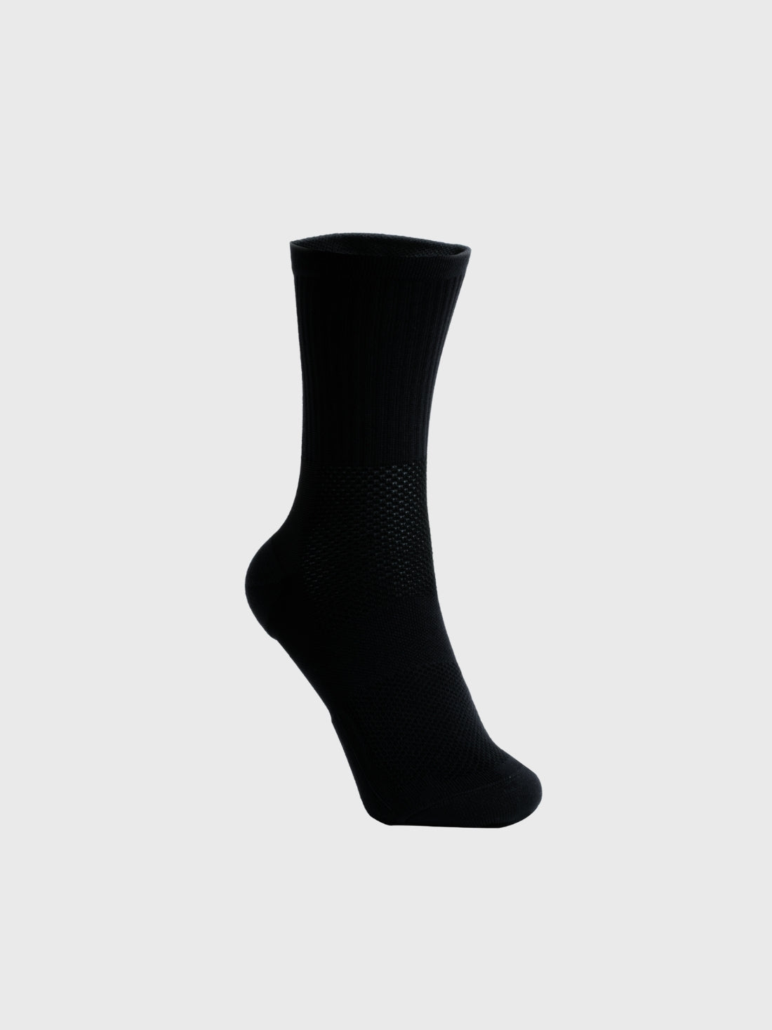 Side profile of a single black POP Running Co running sock against a plain background, highlighting the contoured heel and seamless toe construction.